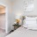 Apartments in Elk Grove, CA - Vasari - Spacious Bedroom with Plush Carpet Flooring, Bed, Nightstand with Lamp, and Large Walk-in Closet