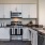Apartments for Rent in Elk Grove, CA - Vasari - Gourmet Kitchen with Vinyl Plank Flooring, Stainless Steel Appliances, Dark Grey Quartz Countertops, and White Cabinetry.